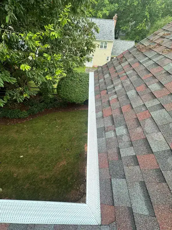 Fine mesh gutter guard fitted along the eave and up the valley of a shingled roof, on one of our jobs.