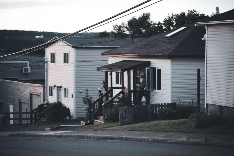 A quiet street of two-storey homes on an overcast day.
